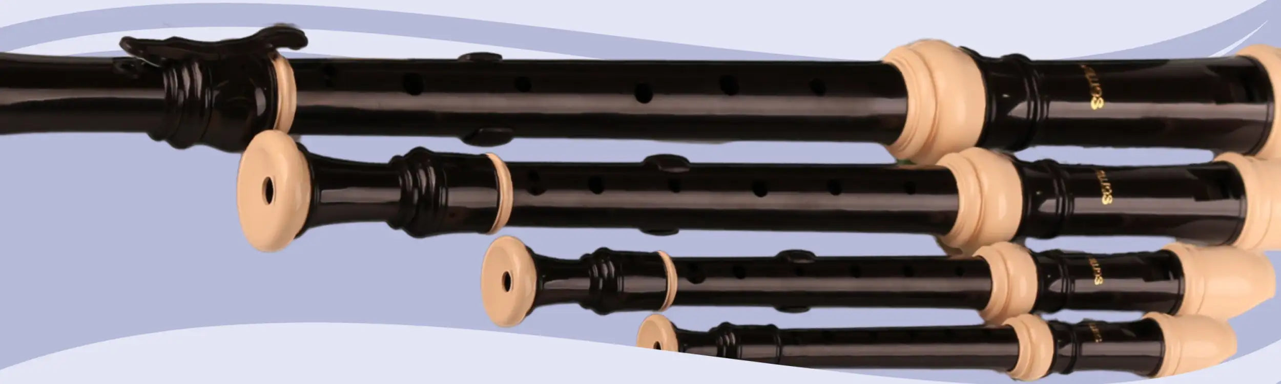Black and cream-colored wooden recorders with gold lettering on the body.