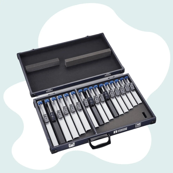 Black hard-shell case containing a set of silver-tipped tuning forks with blue caps and labeled aluminum handles.