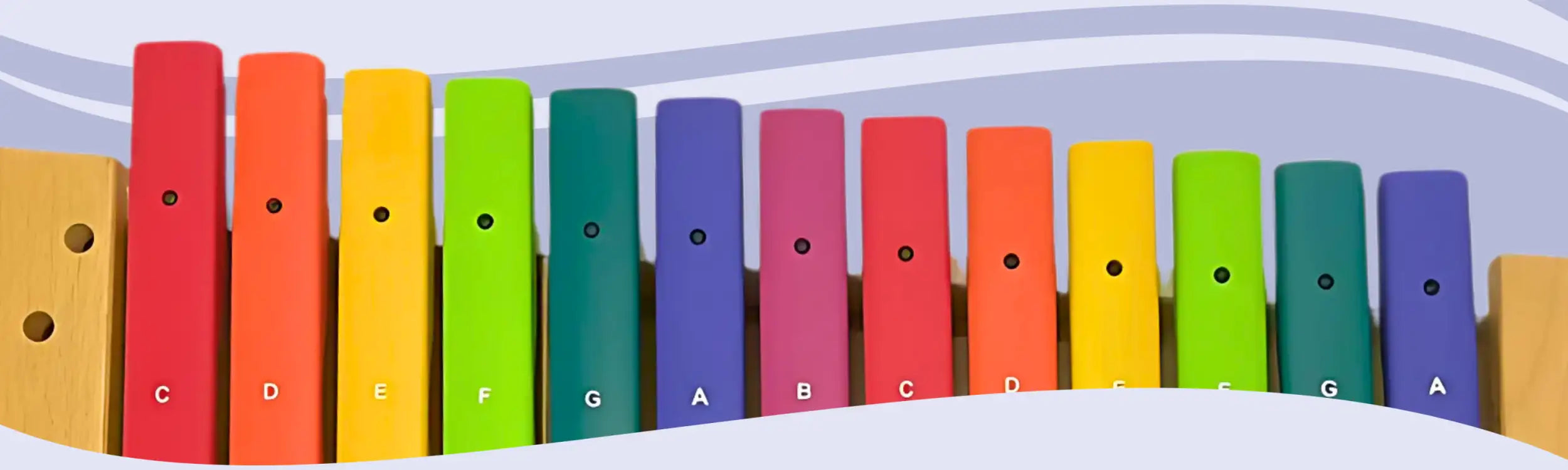 A colorful wooden xylophone with vibrant rainbow-colored bars labeled with musical notes.