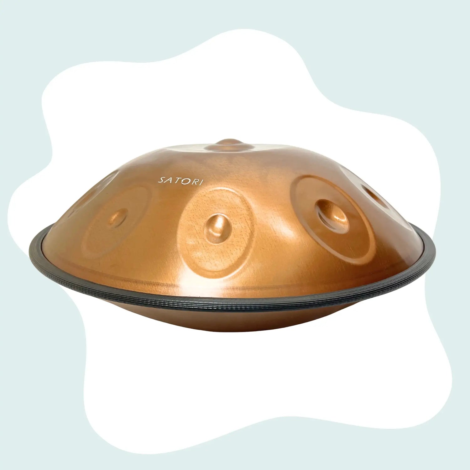 Copper-colored satori handpan with a smooth, domed surface and circular sound holes.