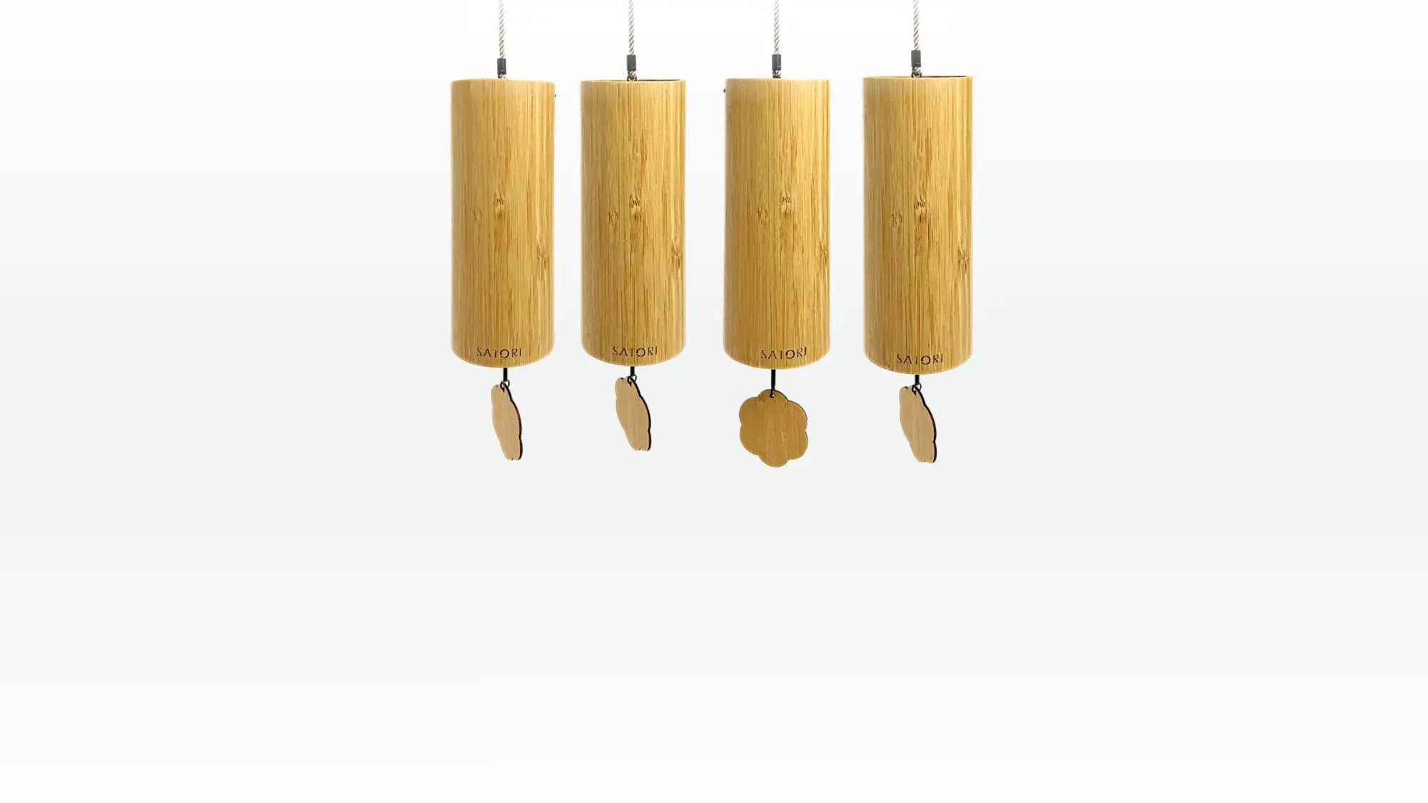 Four light brown bamboo wind chimes, each with a cylindrical body and uniquely shaped wooden clappers hanging below.