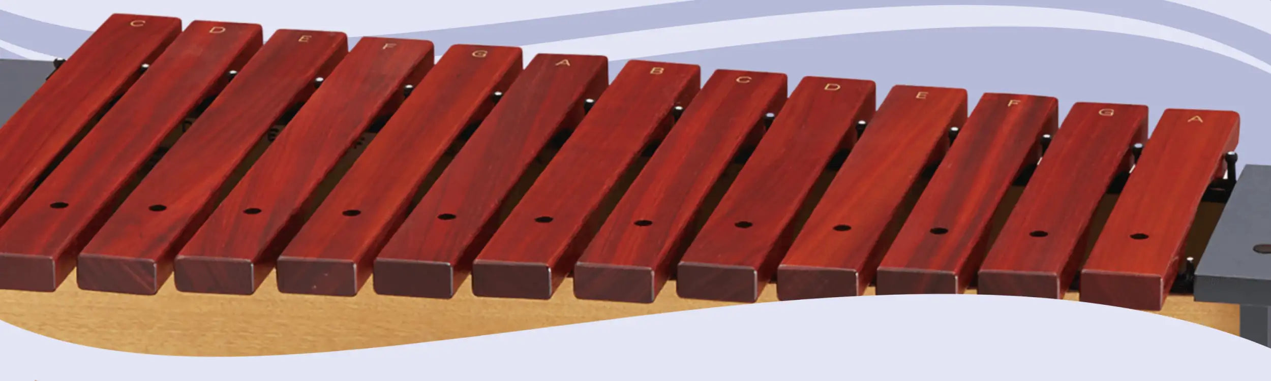 Red wooden xylophone with labeled keys.