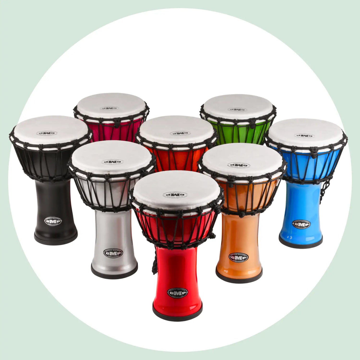 A set of colorful, child-friendly djembe drums with white heads and black tension rings.