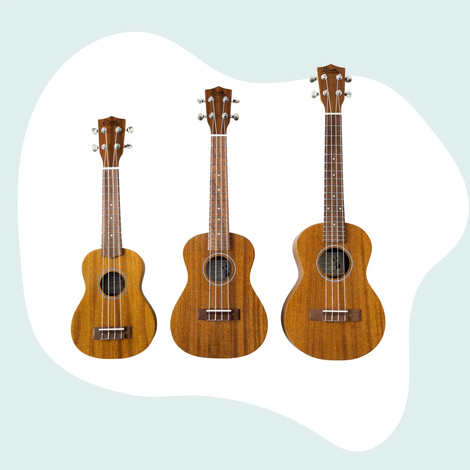Three wooden ukuleles with natural wood grain, silver tuning pegs and dark brown fretboards.