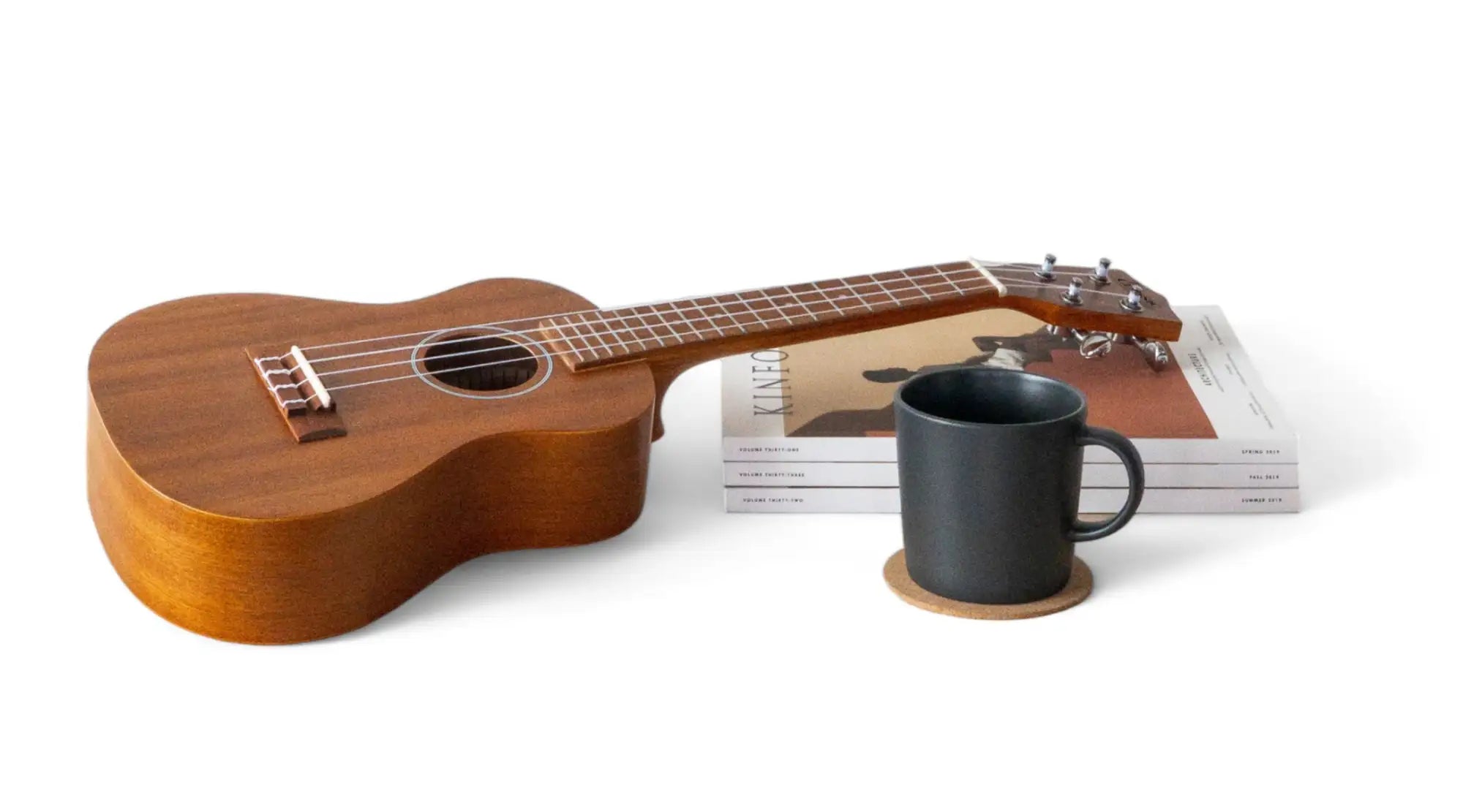 A warm, polished wooden ukulele with a natural wood finish and light brown body.